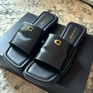 Coach Slides. Black Leather with gold detailing. Never been worn outside. Size 9